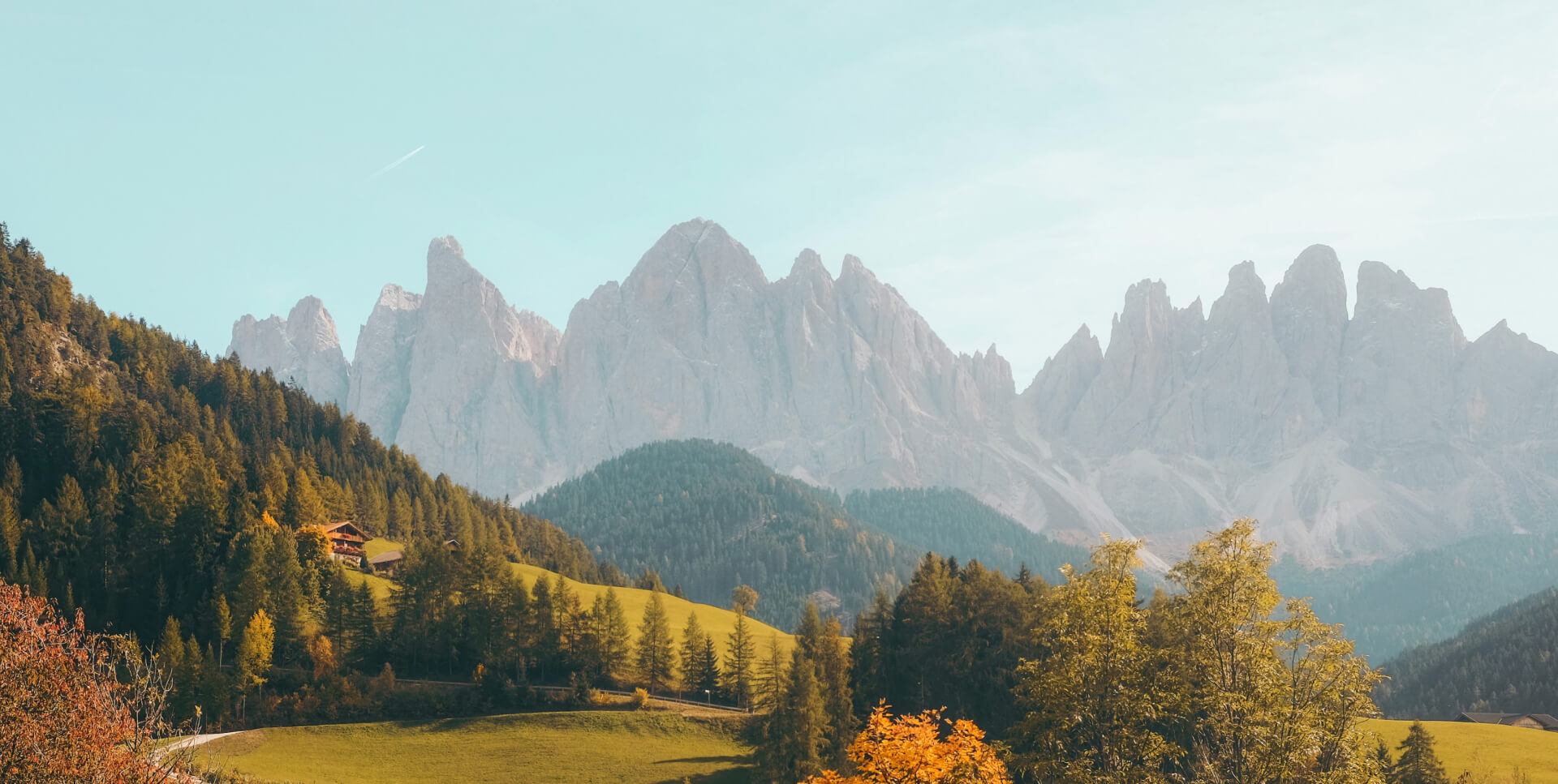 an image having mountains with green trees and natural sunrise